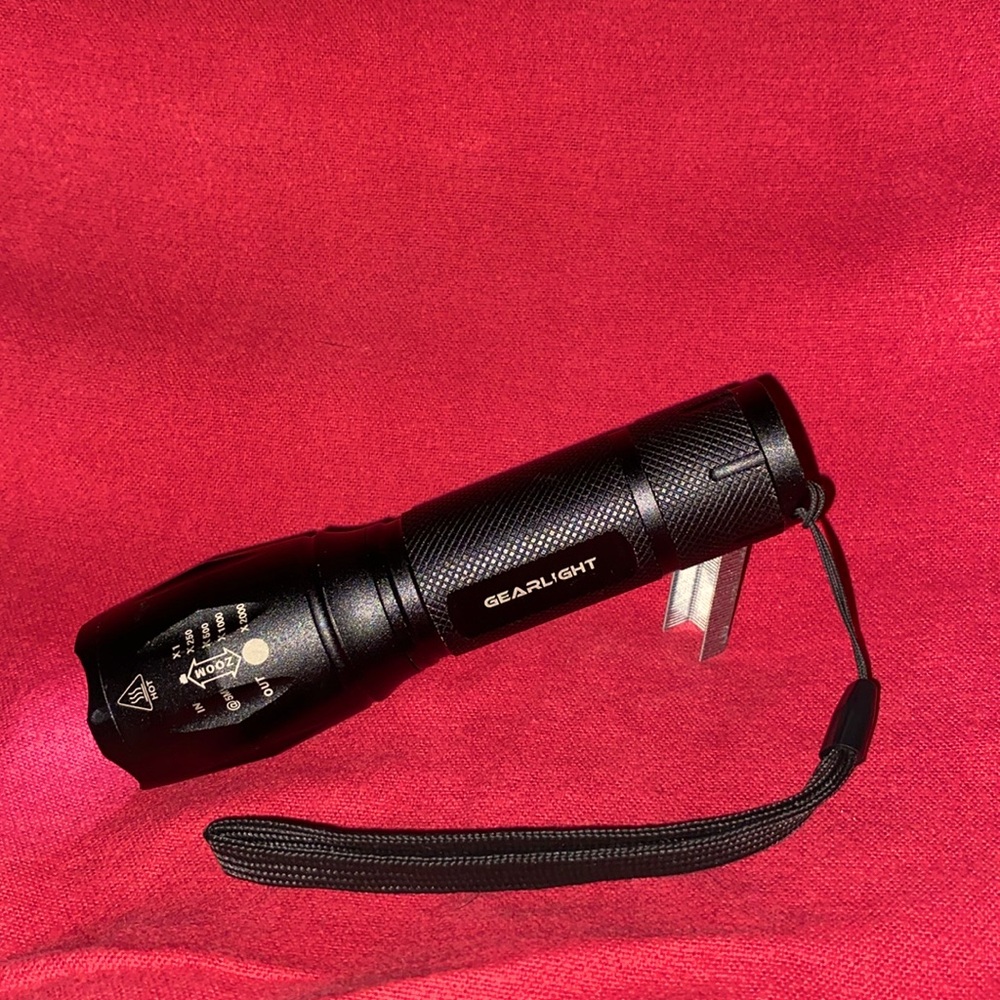 Gearlight Flashlight. All Black. 5” Long. Crisp Orange On/Off Button.